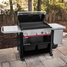 an outdoor bbq grill with two burners and one side door open on a patio