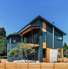 modern house with wooden fence and trees in the front yard stock photo getty images