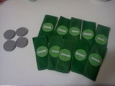 several pieces of green and white paper with tennis balls on them next to some felt circles