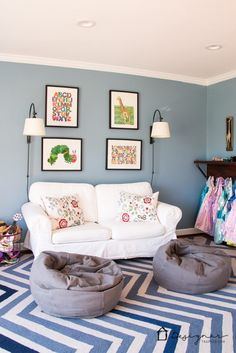 a living room filled with furniture and pictures on the wall