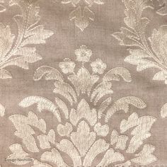 an image of a fabric with flowers and leaves on the side, in grey tones