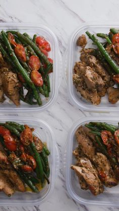 four plastic containers filled with chicken, green beans and tomatoes on top of a marble counter