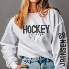 "See store for Christmas deadlines!Its the most wonderful time of the year!! Hockey season! Head to the games in comfort and style with these \"Name and Number Sleeve printed\" Available in a hoodie or sweatshirt this is one sweater that everyone is going to love :)" Hockey Sayings For Shirts, White Tops With Team Spirit For Winter, Winter Fan Apparel Tops With Team Name, White Long Sleeve Tops For Team Events, Hockey Snacks, Hockey Crafts, Hockey Mom Gifts, Casual Mom Style, Hockey Hoodie