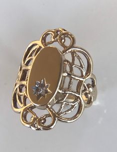 14k open weave signet ring. Big look for a small ring! The open work wraps Nicely around the finger. The oval center has a small diamond that is bright cut in a star pattern. The oval is 11.27x 3.39. The ring weights 1.4 dwt Although the ring is a 3.5 in size, it is a great pinky ring or can be sized up. Yes, it can be engraved by a jeweler! 14k Gold Oval Filigree Promise Ring, Oval 14k Gold Filigree Promise Ring, Antique Oval Diamond Signet Ring, Gold Oval Signet Ring With Diamond Accents, Fine Jewelry Oval Diamond Cut Signet Ring, Yellow Gold Oval Signet Ring With Diamond Accents, Oval Gold Signet Ring With Diamond Accents, Oval Diamond Cut Signet Ring For Promise, Engraved 14k Gold Ring With Diamond Accents, Oval Shape