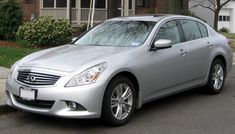 a silver car parked in front of a house