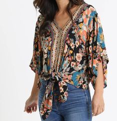 Black, floral, boho top with a tie waist Spring Beach Tops With Tie Waist, Casual V-neck Blouse With Boho Collar, Casual Printed Tie Neck Blouse, Casual Tie Neck Printed Blouse, Casual Printed Blouse With Tie Neck, Casual Tie Neck Top For Vacation, Bohemian Floral Print Tops For Fall, Spring Tops With Tie Waist And Tie Neck, Spring Tie Waist Tie Neck Top