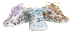 three porcelain shoes with flowers on them