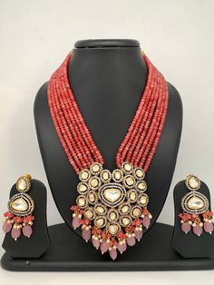 Kundan AD Pendent with Pink Onyx Beads Necklace Necklace Length : 16 Inches; Earring Length : 2.5 Inches Dangling Kundan Beads Necklace For Party, Kundan Necklace With Dangling Beads For Party, Traditional Pink Beaded Necklace, Kundan Necklaces With Faceted Round Beads, Kundan Necklaces With Faceted Beads, Pink Temple Jewelry Necklace With Round Beads, Traditional Pink Necklaces With Colorful Beads, Pink Temple Jewelry Beaded Necklace For Festivals, Pink Kundan Necklace With Round Beads