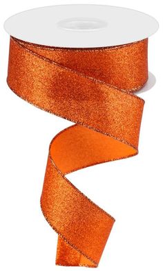 a roll of orange glitter ribbon on a white background