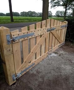 a large wooden gate with metal straps on it