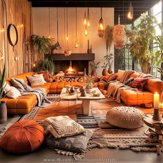 a living room filled with lots of orange couches and pillows next to a fire place