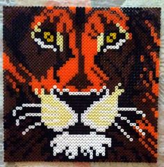 a close up of a beaded picture of a cat