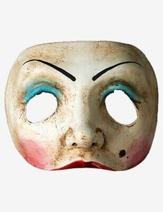 an old mask with blue eyes and red nose is shown in front of a white background