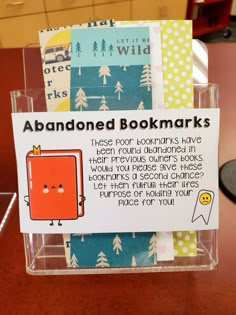 a bookmark holder with an orange book on it's front and back sides