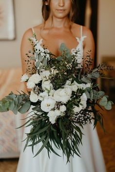 a woman holding a bouquet of flowers in her hands