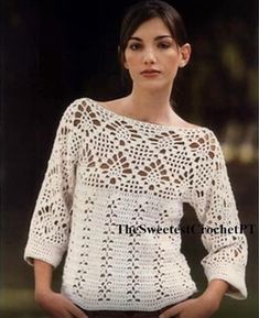 a woman wearing a white crochet sweater