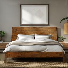 a bed with white linens and pillows in a room next to a plant on the wall