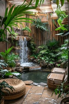 a small waterfall in the middle of a tropical garden