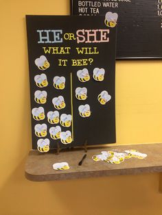 a sign that says he or she what will it bee? on the wall next to some beer bottles