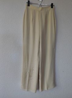 "Elegant vintage pants suit in cream color Simple design/minimalist Floral pattern with beads on front left shoulder and right bottom side of pants Top side slits Pants lined, back zipper Material - 100% polyester Right side pant has a pulled thread at ankle as shown in the photos. When worn, tunic top covers it. Otherwise, condition is great. Dimension Top - shoulder 15.5\" bust 40\" sleeve 23\" length 32\" Pants - waist 13.5\" rise 13\" inseam 28\" out seam 40\" hemline 9.5\"" Elegant Embellished Pants For Spring, Elegant Embellished Summer Pants, Embellished Bottoms For Formal Spring Events, Beige Pants For Spring Evening, Cream Bottoms For Spring Evening, Beaded Pants, Cotton Lace Tops, Sheer Pants, Side Pants