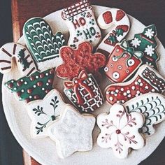 a white plate topped with lots of decorated cookies