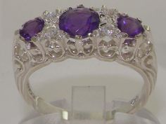 three stone ring set with diamonds and amethyst purple stones in white gold setting