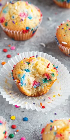 cupcakes with sprinkles are on paper plates