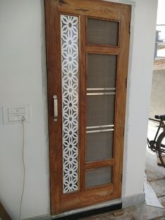 a wooden door with decorative glass on the side