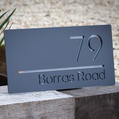 there is a sign that says borra's road on the side of a wooden block