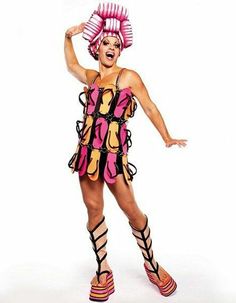 a woman in a pink and yellow costume posing for the camera with her hands on her hips