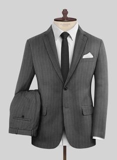 Attain a fashionable and modish look with our Napoleon Genova Stripe Dark Gray Wool Suit. Crafted from a superior blend of wool, it presents a dark gray color adorned with a subtle stripe design, marrying timeless charm with a touch of modern sophistication ensuring a distinguished look and a comfortable feel. Whether you're making a powerful statement or embracing casual sophistication, this suit ensures you command the room and every stylish moment with effortless poise and confidence. 
  Look Includes   Napolean Genova Stripe Dark Gray Wool Fabric  Two Button Jacket Style  Notch Lapel  Horn Royal Black Buttons  Single Vent  Three Cuff Buttons  Two Welted Back Pockets on Trousers   Click 'Customize Now' to modify the look if needed. 
 
Lining: Viscose, Dry Clean, Pants can be lightly was Striped Fitted Suits For Business Casual, Tailored Striped Wool Suits, Formal Striped Wool Suit, Striped Wool Suit For Workwear, Pinstripe Suit With Suit Collar For Office Wear, Striped Wool Suits For Work, Striped Wool Suits, Pinstripe Wool Suit For Office, Striped Semi-formal Suits With Welt Pockets