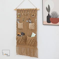 a woven wall hanging with various items on it