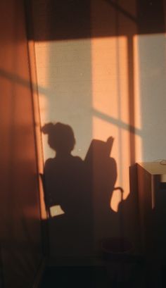 the shadow of a person sitting in a chair