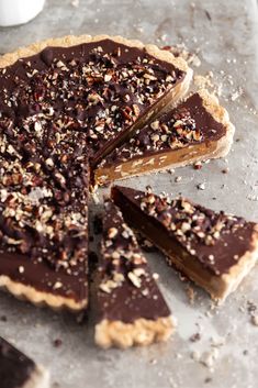 there is a chocolate pie with one slice cut out and the other half on top