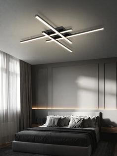 a bedroom with a large bed and two lights above the headboard on the ceiling