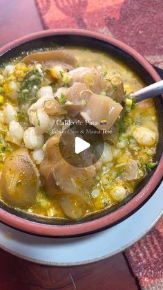 a bowl filled with soup sitting on top of a table