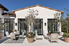 an outdoor patio with potted plants and chairs