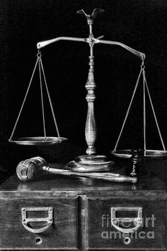 an old wooden balance scale sitting on top of a chest of drawers in black and white