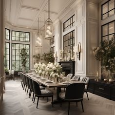 an elegant dining room with white flowers and black chairs