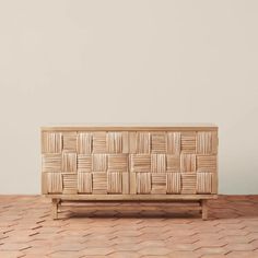 a wooden box sitting on top of a table next to a white wall and floor