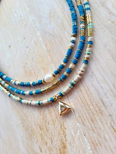 Heishi bead necklaces in polymer clay and 18k gold plated hematite beads.  18k gold plated fastenings and findings.  Choose from 3 pretty necklaces. Length:  16"  (+5cm extender chain) Beads:   4mm 1. Fresh water pearl: 9mm x 7mm (approx) 2. Gold centre 3. Triangle cz pendant: 12.5mm x 12.5mm  💫Care for your jewellery by avoiding water, perfumes and lotions when wearing and remove before bathing. 👉Follow me @Bohoseason  on Facebook & Instagram  Any questions?...i'm happy to help 😊 📦overpaid Adjustable Gold Heishi Beads Necklace, Gold Heishi Beads Jewelry With Wooden Beads, Handmade Gold Necklace With Heishi Beads, Heishi Necklace, Boho Jewellery, Pretty Necklaces, Cz Pendant, Heishi Beads, Pearl Pendant Necklace