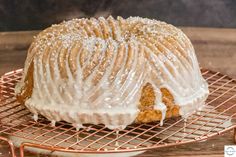 a bundt cake with icing sitting on a cooling rack