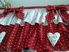 red and white polka dot ruffled valance with heart appliqued on it