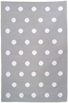 a gray rug with white polka dots on it