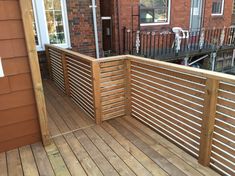 a wooden deck next to a brick building