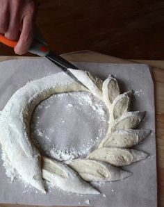 a person is cutting dough with a knife