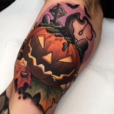 a man's arm with a pumpkin tattoo on it