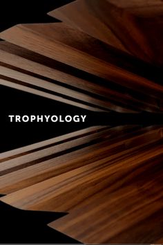 the words trophylogy are written in white on top of wood planks