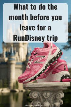 a pair of pink running shoes sitting on top of a white railing with the words, what to do the month before you leave for a rundisney trip