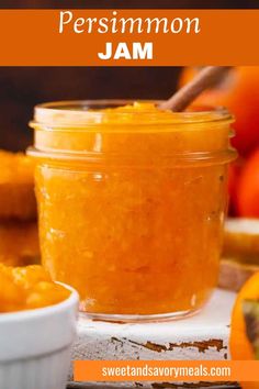 a jar with persimmon jam with a wooden spoon